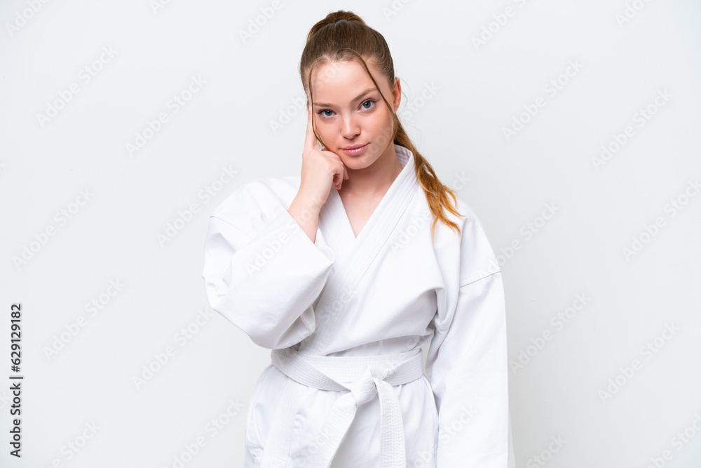 Young caucasian girl doing karate isolated on white background thinking an idea Young caucasian girl doing karate isolated on white background thinking an idea