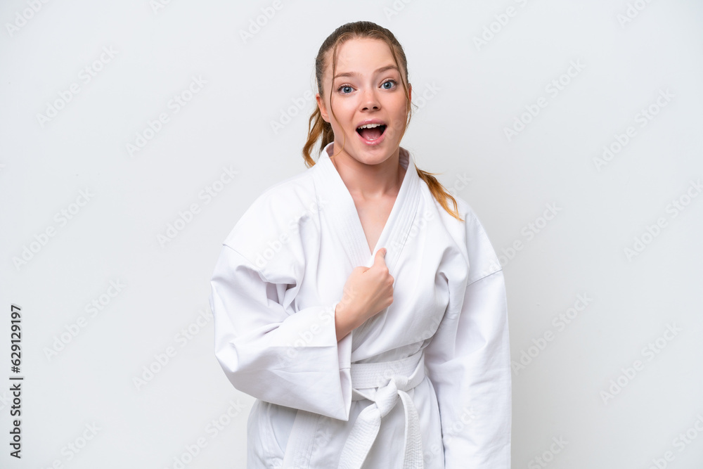 Young caucasian girl doing karate isolated on white background with surprise facial expression Young caucasian girl doing karate isolated on white background with surprise facial expression