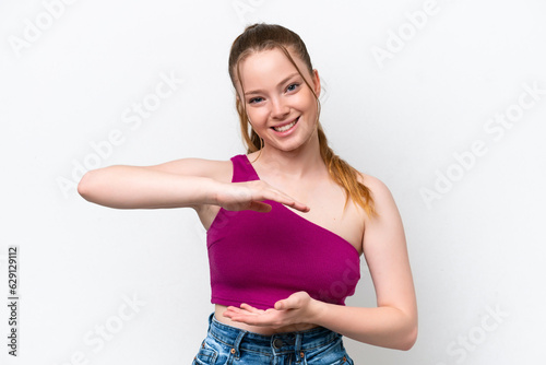 Young caucasian girl isolated on white background holding copyspace imaginary on the palm to insert an ad © luismolinero