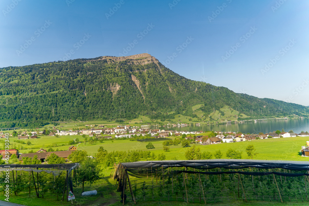 Scenic view of Swiss Lake Zug on a sunny spring day with famous Mount Rigi and Swiss town of Arth in the background on a sunny spring day. Photo taken May 22nd, 2023, Lake Zug, Switzerland.