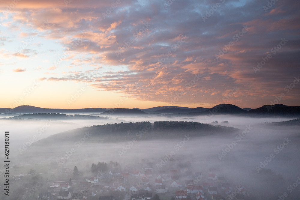 Mystical Sunrise at Wachtfelsen, Palatinate Forest. Captivating landscape shot amidst fog and clouds near Wernersberg, Germany