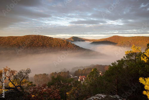 Mystical Sunrise at Wachtfelsen, Palatinate Forest. Captivating landscape shot amidst fog and clouds near Wernersberg, Germany photo