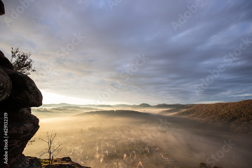 Mystical Sunrise at Wachtfelsen, Palatinate Forest. Captivating landscape shot amidst fog and clouds near Wernersberg, Germany photo