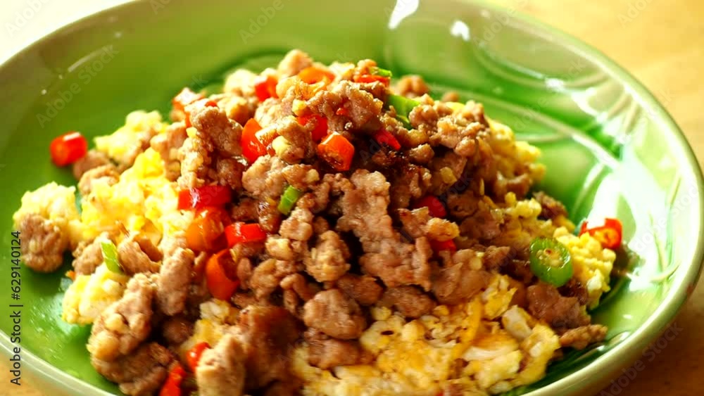 Minced pork with chili on scramble eggs in plate, in door Chiangmai Thailand. Minced pork with chili on scramble eggs in plate, in door Chiangmai Thailand.