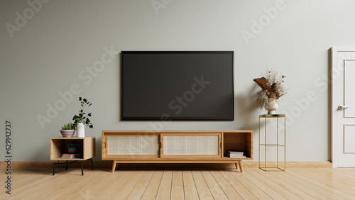 TV on the cabinet in modern living room on gray wall background.