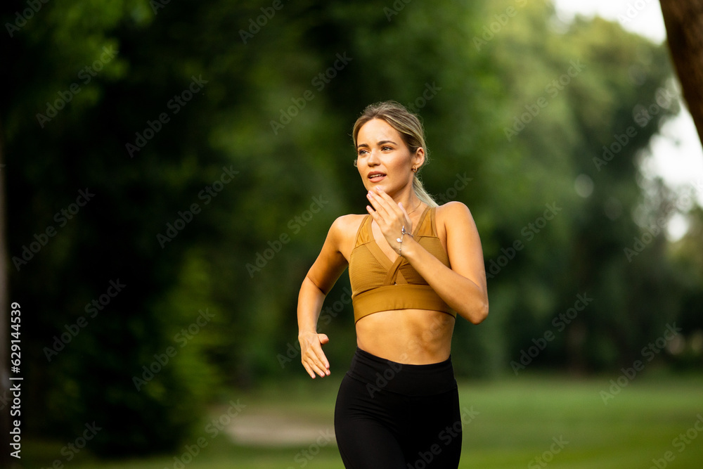 Pretty young woman running in the park Pretty young woman running in the park