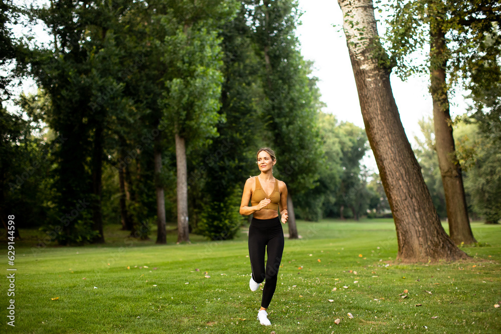Pretty young woman running in the park Pretty young woman running in the park