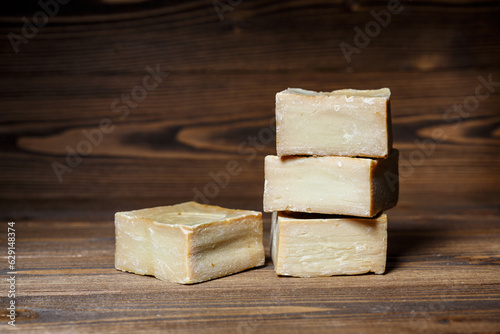 Bars of traditional aleppo natural laurel soap on a wooden background.