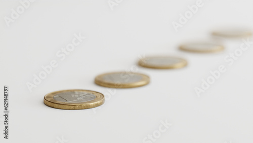 Several euro coins lying on a white surface