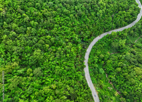 Road in the middle of the forest , road curve construction up to mountain, Rainforest ecosystem and healthy environment concept