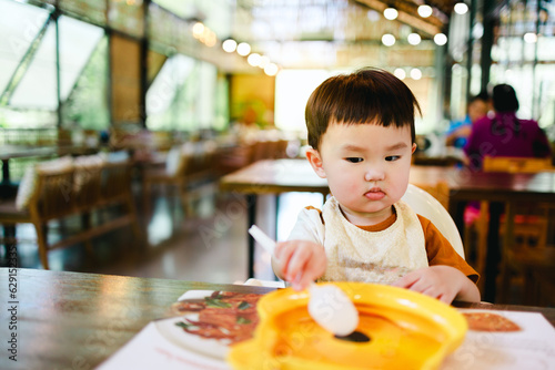 Child with frown face when eating