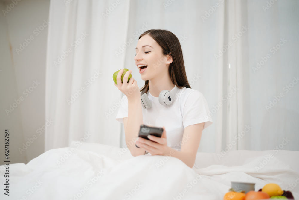 Good Healthy woman drinking tea and resting in white bed at bedroom. Lifestyle at home concept in morning.. Good Healthy woman drinking tea and resting in white bed at bedroom. Lifestyle at home concept in morning..
