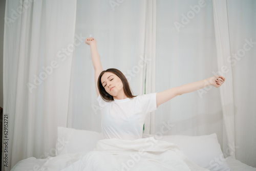 Image of beautiful woman resting in white bed at bedroom. in morning . Lifestyle at home concept..