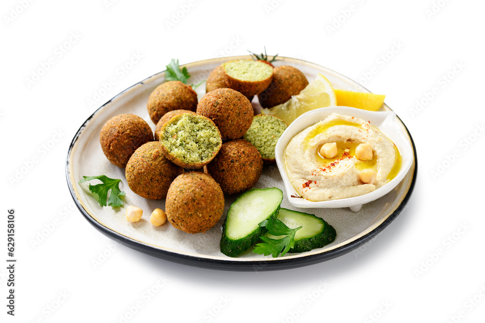 Plate of chickpeas falafel balls with hummus, vegetables  and lemon slices. isolated on white background