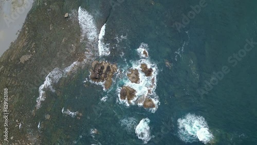 deep blue aerial view of the waves in the rocks in the cantabric sea photo