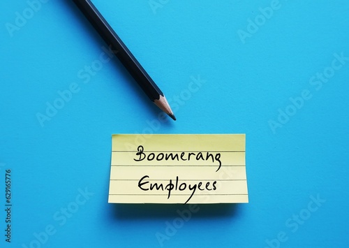 Pencil wrote on yellow note on blue background - Boomerang Employees - workers returning to a former employer as a rehired employee after leaving company for any reasons photo