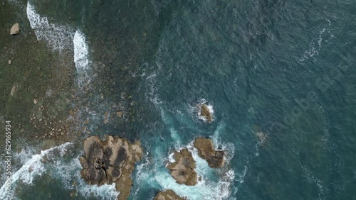 aerial view of the coastline in the cantabric sea with the waves hitting the rocks photo
