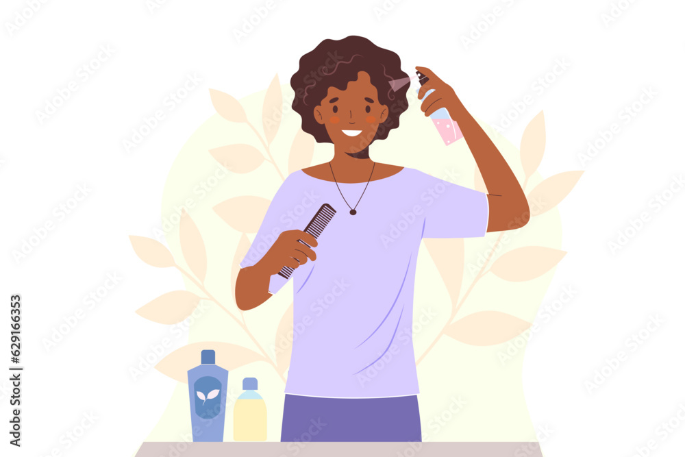 Young african american woman takes care of her hair, applying moisturizing spray to curly hair Young african american woman takes care of her hair, applying moisturizing spray to curly hair