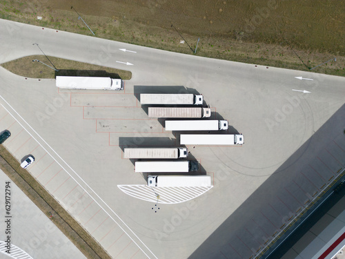 aerial drone view of parking with trucks and trailers 