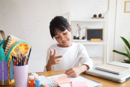 Mixed race student counting on fingers in living room. girl doing math homework. child counting and studying together in a house.