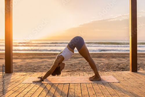 woman doing yoga exercise on beach