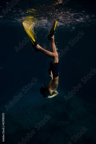 Unrecognizable man in flippers swimming underwater © ADDICTIVE STOCK CORE