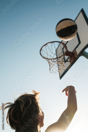 Kid throwing basketball into hoop © ADDICTIVE STOCK CORE