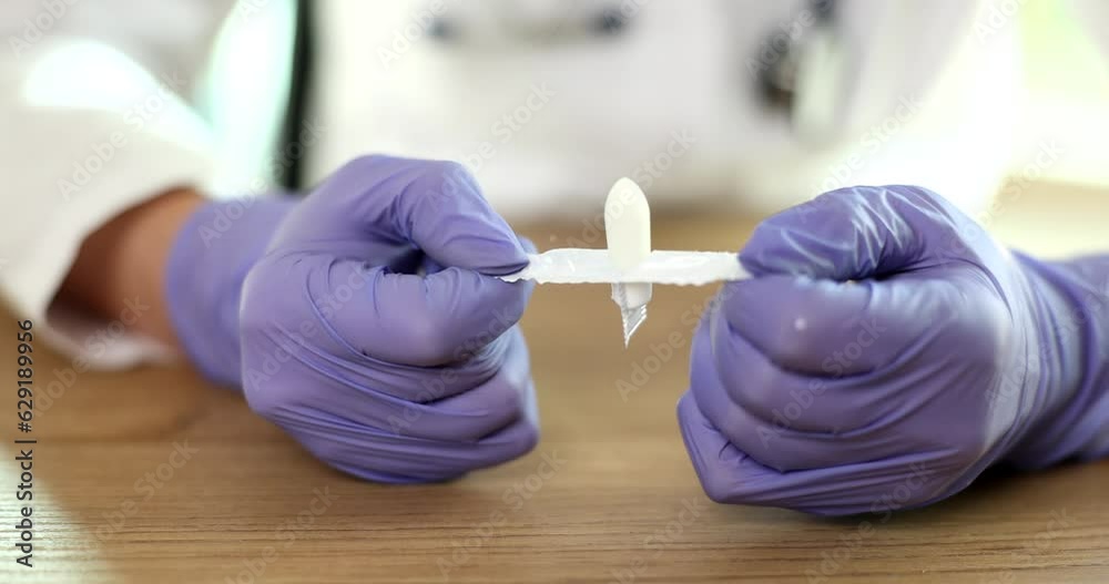 Doctor gynecologist in gloves opening antiinflammatory suppository