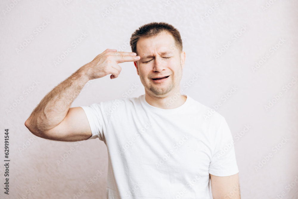 The guy holds his hands in the form of a pistol at his temple. Men's health prostate prevention The guy holds his hands in the form of a pistol at his temple. Men's health prostate prevention