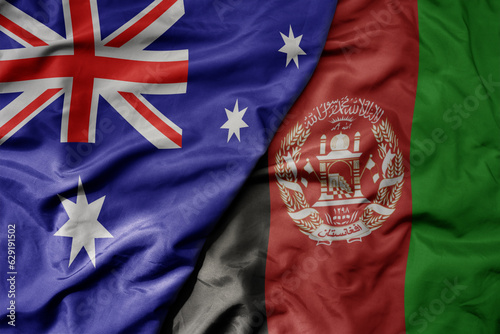 big waving realistic national colorful flag of australia and national flag of afghanistan .
