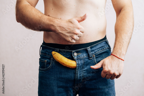 The guy is holding a banana in his jeans. Men's health prostate prevention