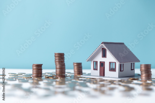 Property tax.investment planning.business real estate. View Of coin stack with house model, mortgage loading real estate property with loan money bank concept.Home sales and home insurance concept.