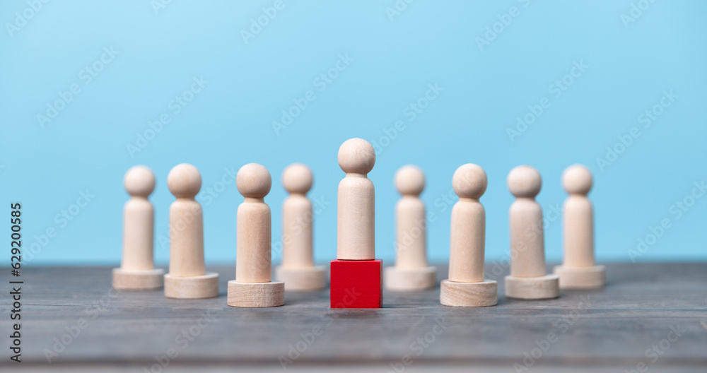 Wooden figure standing on the box for show influence and empowerment. Concept of business leadership for leader team, successful competition winner and Leader with influence Wooden figure standing on the box for show influence and empowerment. Concept of business leadership for leader team, successful competition winner and Leader with influence
