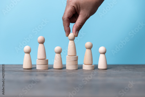 Building a strong team  Wooden blocks with people icon on blue background  Human resources and management concept.