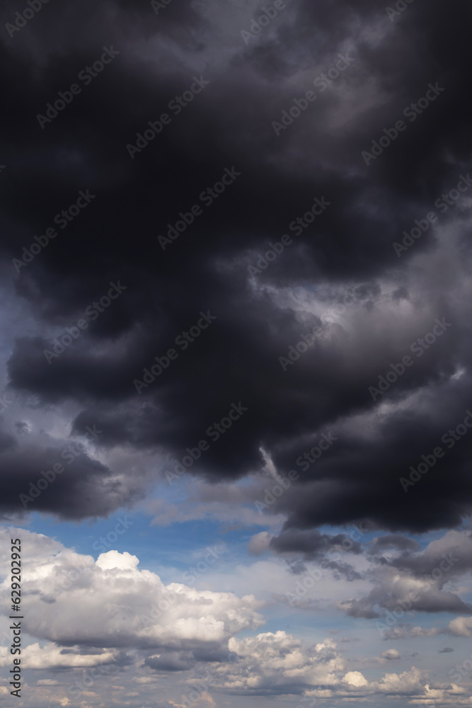 Storm rainy dramatic sky with dark rain grey cumulus clouds and blue sky background texture, thunderstorm, heaven