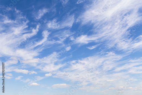 Beautiful soft gentle cloudy blue sky with white cirrus clouds, abstract background texture