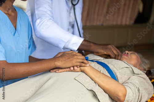 Nurse is holding a patient hand to ease and make her comfortable with emergency treatment.