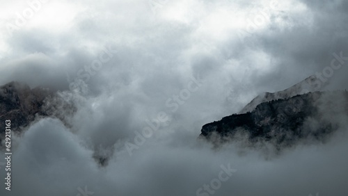 Mountains rising from the clouds. Dolomites, Italy © Petrolini Massimiliano/Wirestock Creators