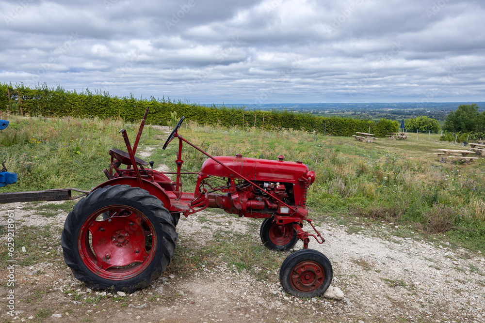 Red tractor near Monbazillac castle (Chateau de Monbazillac), Dordogne department, Aquitaine, France Red tractor near Monbazillac castle (Chateau de Monbazillac), Dordogne department, Aquitaine, France