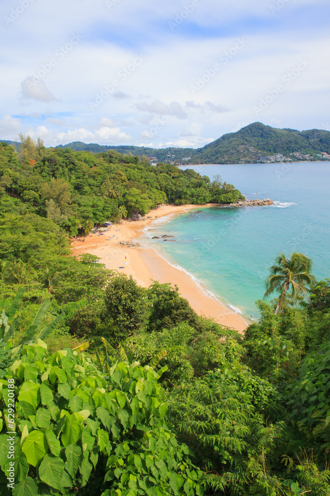 Tropical sandy beach landscape from high view point. Beautiful turquoise ocean and people relaxing in Laem Sing beach Phuket, Thailand