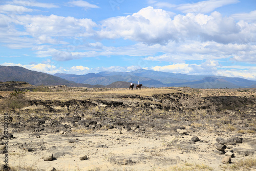 Riders in Tatacoa Desert in Colombia, 2 men in horses riding the desert