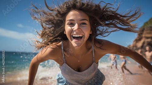 happy young woman jumping on the sandy beach