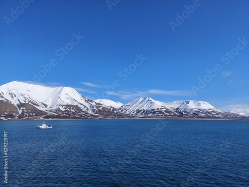 Serene Winter Landscape: Majestic Mountains, Pristine Snow, and Tranquil Sea a view from svalbard and jan mayen norway