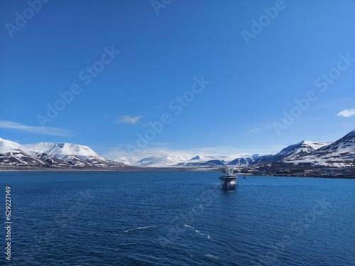 Serene Winter Landscape  Majestic Mountains  Pristine Snow  and Tranquil Sea a view from svalbard and jan mayen norway
