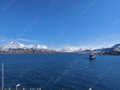 Bilde på lerret Serene Winter Landscape: Majestic Mountains, Pristine Snow, and Tranquil Sea a v