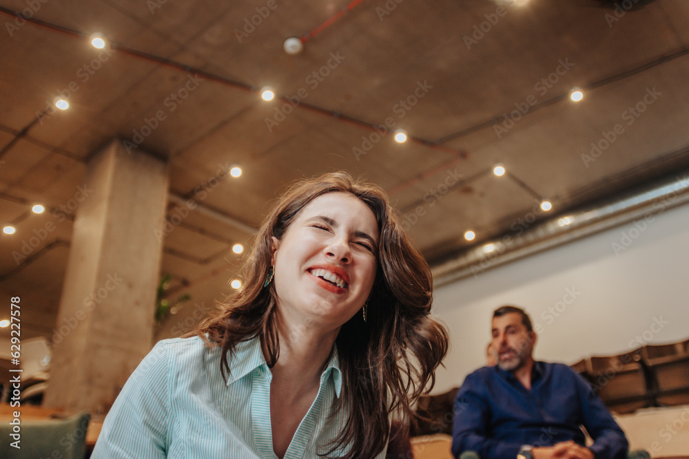 Brunette businesswoman laughing at work