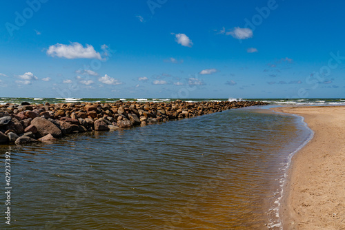 Fototapeta Naklejka Na Ścianę i Meble -  The rubble mound at the small rivers mouth in the Baltic sea.
