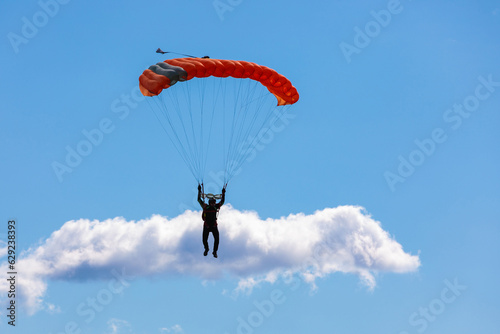 Parachute in the sky. Skydiver is flying a parachute in the blue sky