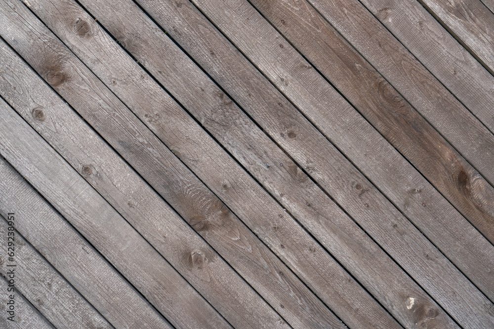 A wall of old, weathered boards with nails. Background texture.