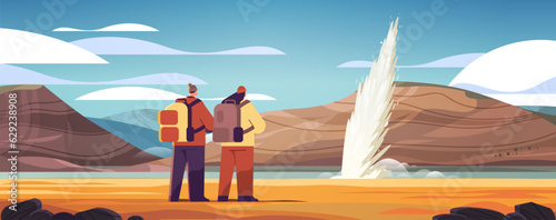 tourists couple near impressive eruption of active geyser hot water steam spraying out from under ground power fountain outdoor